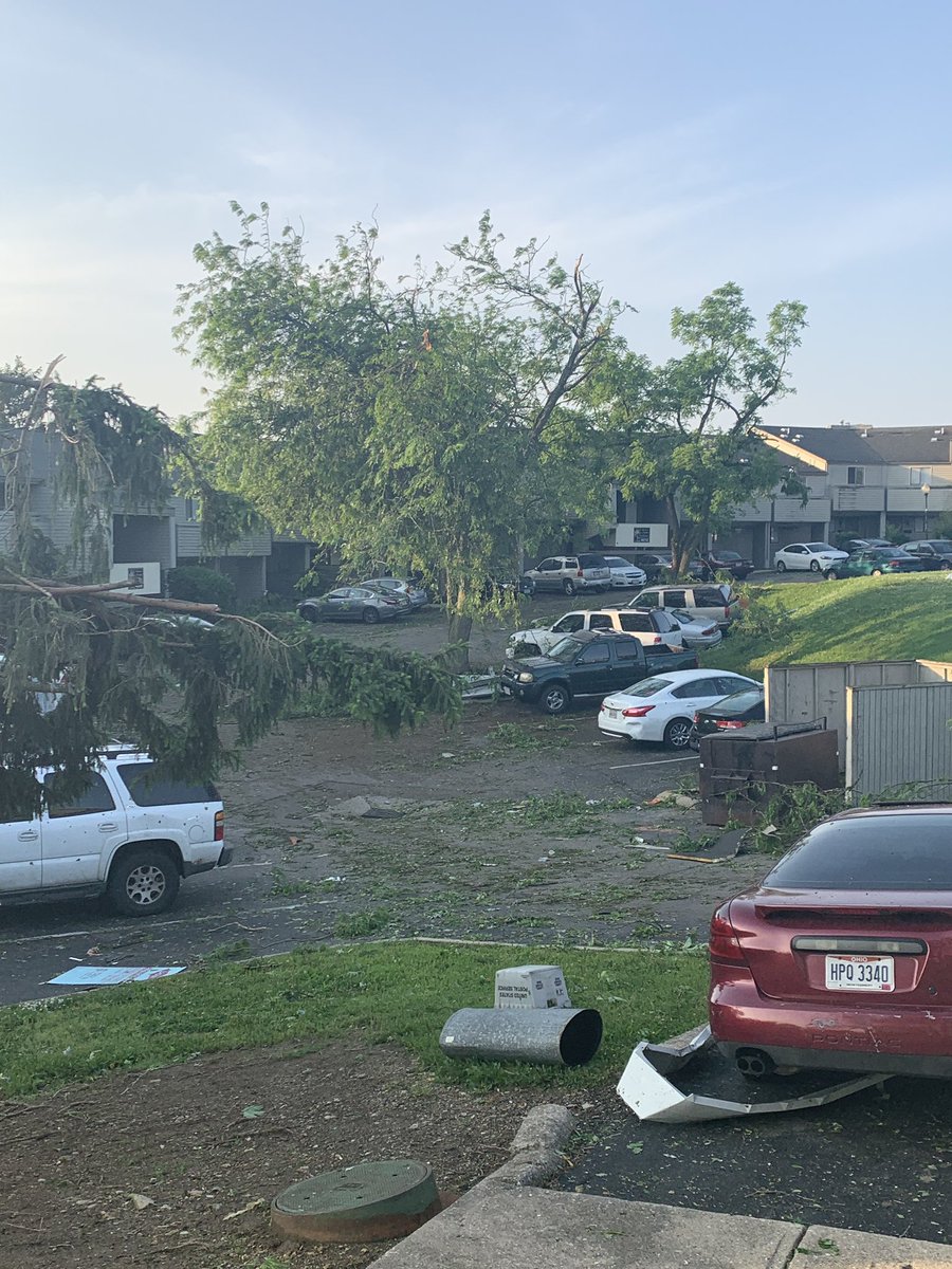 Apartment complex after the tornado in dayton. several cars destroyed, big trees completely knocked over.   dayton 