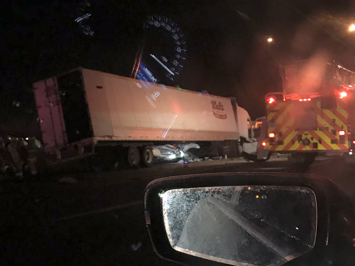 Vehicle trapped under semi at the NB 71/75 merge. Traffic slowed going both ways. 