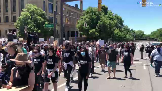 Protesters chant Say his name. George Floyd. as they march downtown