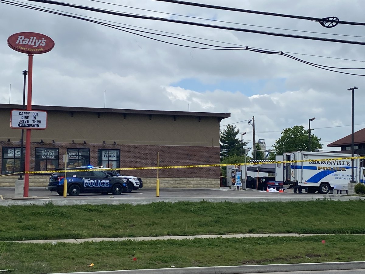 Sharonville PD on scene of a homicide at Rally's in E. Sharon Rd. Police say male victim was shot in his car while in the drive-thru line. Suspect fled in late 90's/ early 2000's dark green Thunderbird with damage to rear passenger window. Ohio plates