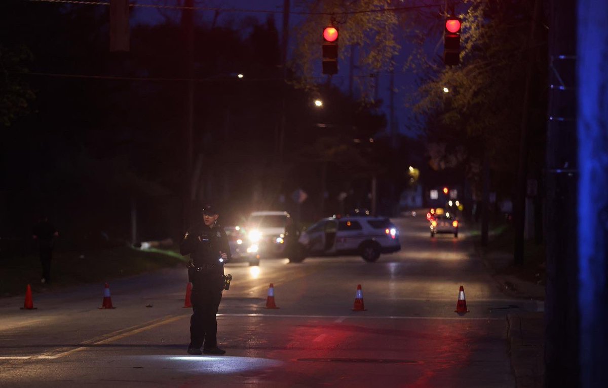 Police officers investigate the scene of a shooting that took the life of a child at Jackman Road and Hillcrest Avenue in Toledo on Wednesday.  