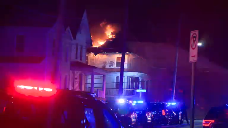 Police and firefighters are at the scene of a burning home in Hamilton